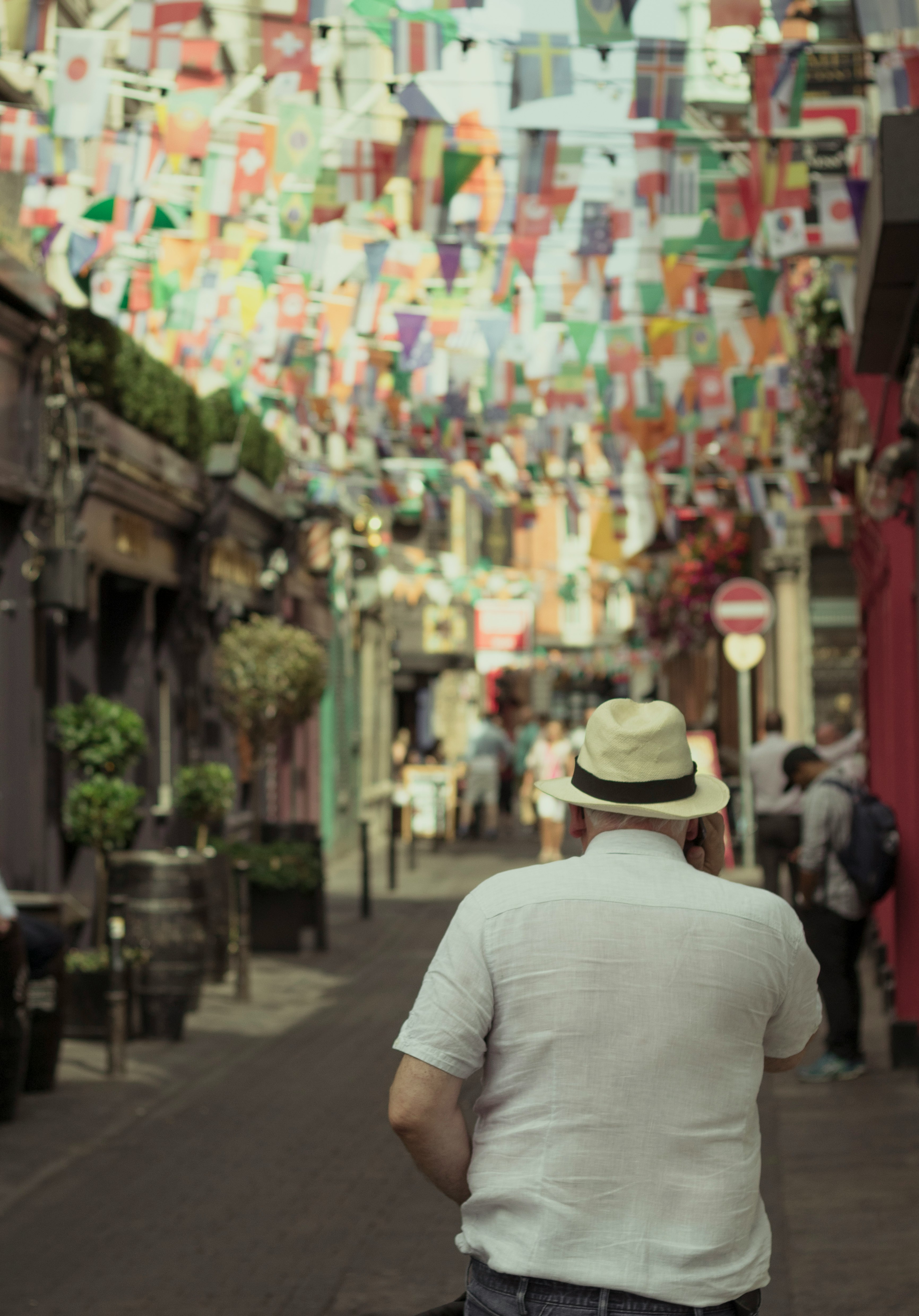 man walking on city street at daytime